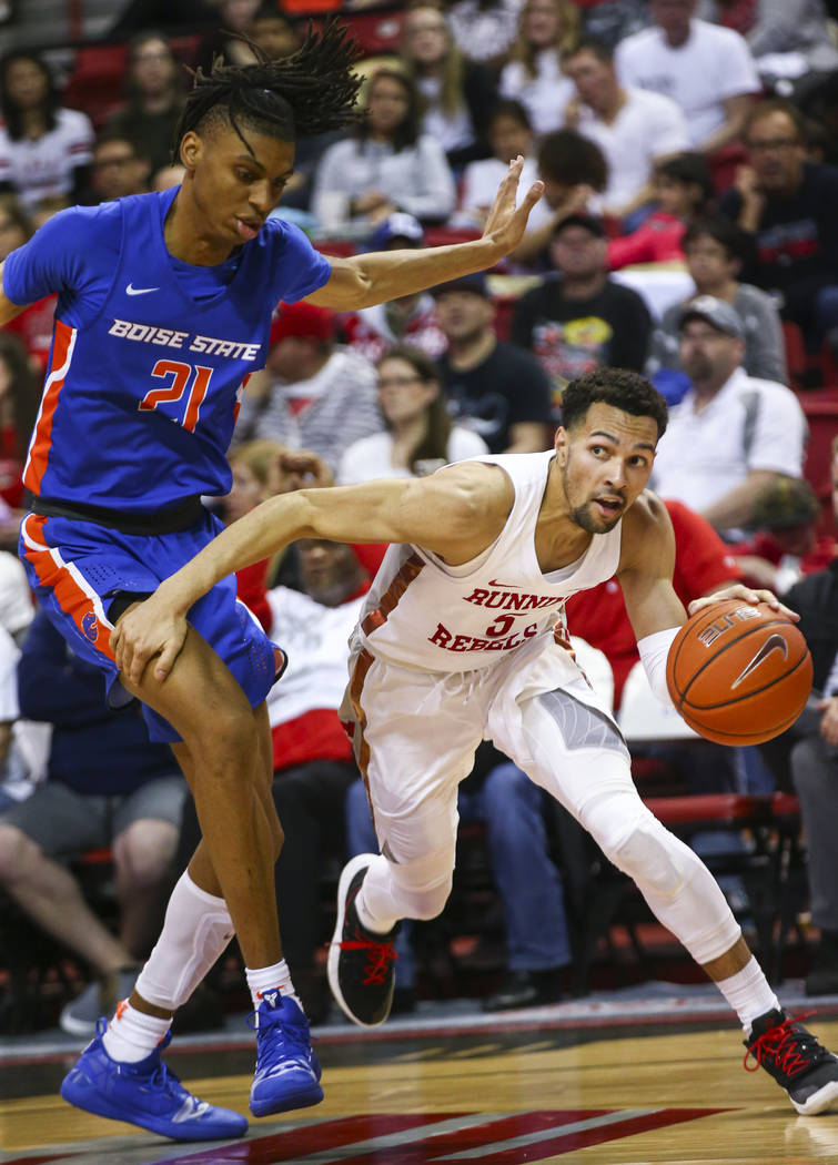 UNLV Rebels guard Noah Robotham (5) moves the ball around Boise State Broncos guard Derrick Alston (21) during the second half of a basketball game at the Thomas & Mack Center in Las Vegas on ...