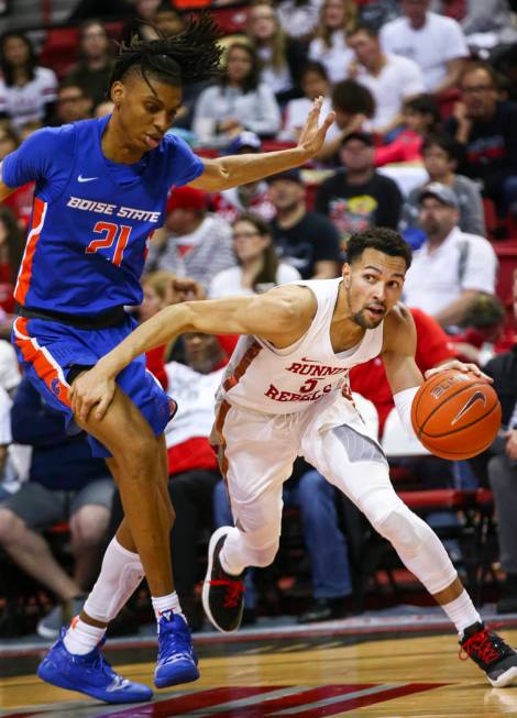UNLV Rebels guard Noah Robotham (5) moves the ball around Boise State Broncos guard Derrick Alston (21) during the second half of a basketball game at the Thomas & Mack Center in Las Vegas on ...