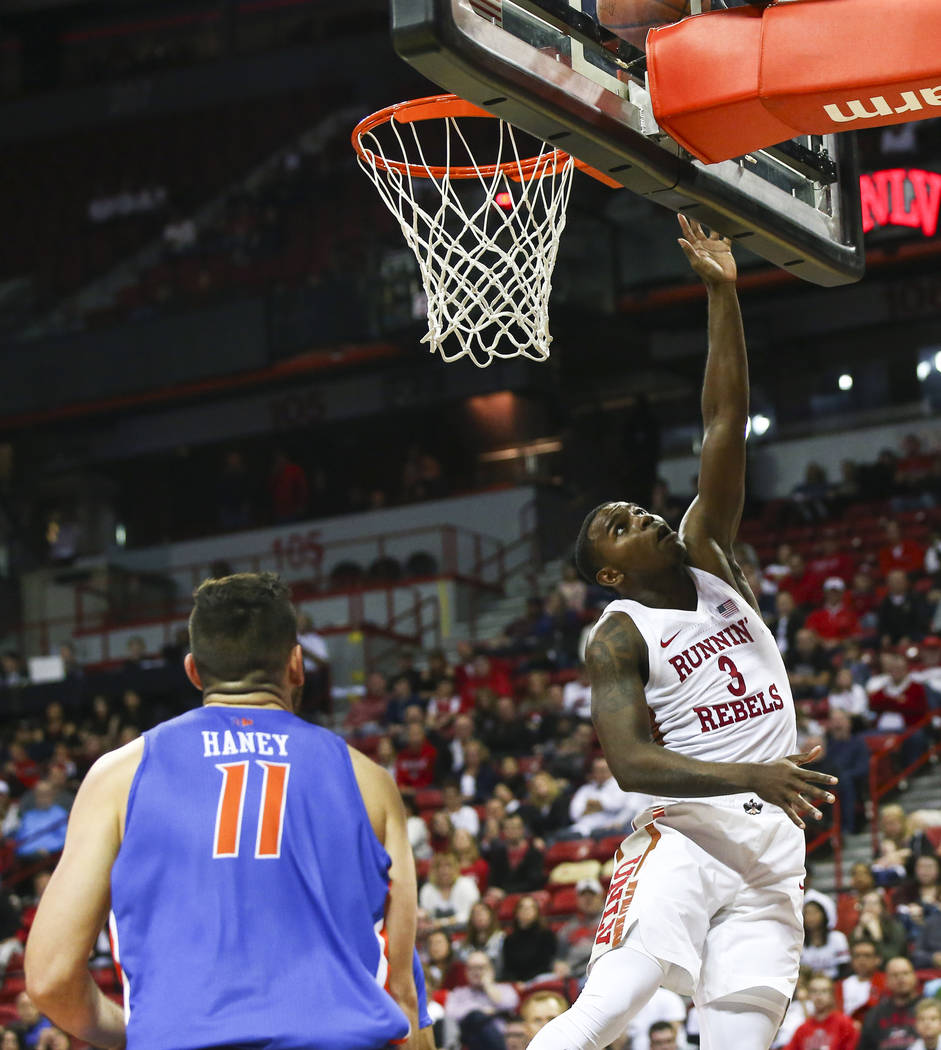 UNLV Rebels guard Amauri Hardy (3) goes to the basket past Boise State Broncos guard Zach Haney (11) during overtime in a basketball game at the Thomas & Mack Center in Las Vegas on Saturday, ...