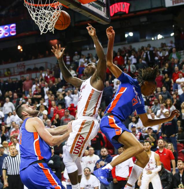 UNLV Rebels guard Amauri Hardy (3) gets fouled by Boise State Broncos guard Derrick Alston (21) during the second half of a basketball game at the Thomas & Mack Center in Las Vegas on Saturday ...