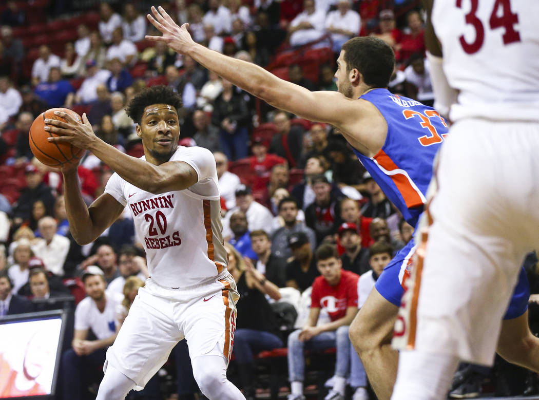 UNLV Rebels forward Nick Blair (20) moves the ball around Boise State Broncos forward David Wacker (33) during the second half of a basketball game at the Thomas & Mack Center in Las Vegas on ...