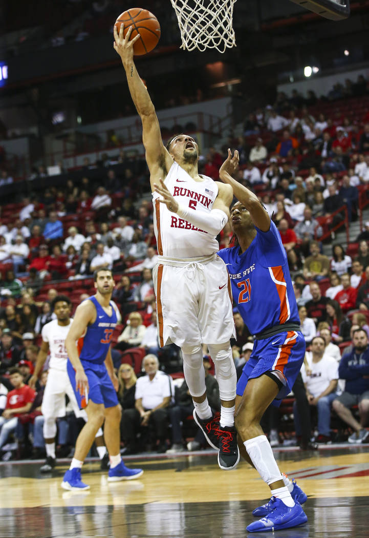 UNLV Rebels guard Noah Robotham (5) goes to the basket past Boise State Broncos guard Derrick Alston (21) during the second half of a basketball game at the Thomas & Mack Center in Las Vegas o ...
