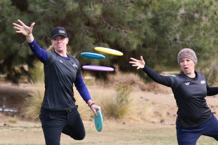 Ellen Widboom of Brooksville , Fla., left, and Lia Fajkus, Austin, Texas, attempt to throw their discs into the basket during practice at Wildhorse Golf Club on Wednesday, Nov. 20, 2019, in Hender ...