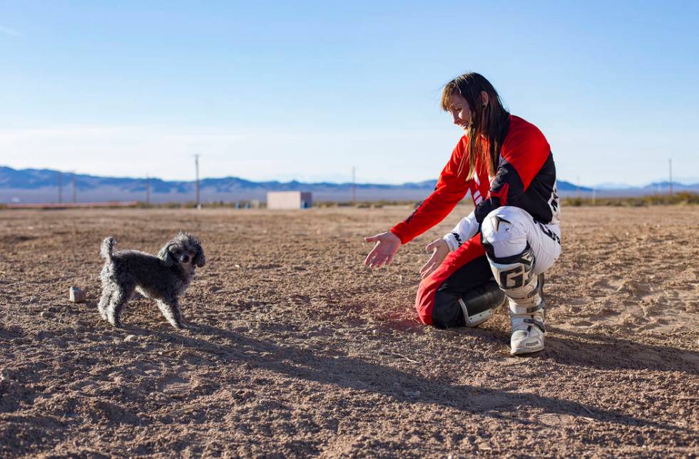 Angie Wright plays with her dog, Phoenix, at Western Raceway track outside White Hills, Arizona, Sunday, Feb. 24, 2019. Wright will be racing in the Mint 400's motorcycle race, the first dirt bike ...