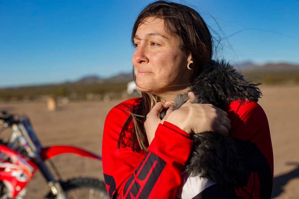 Angie Wright holds her dog Phoenix at Western Raceway track outside White Hills, Arizona, Sunday, Feb. 24, 2019. Wright will be racing in the Mint 400's motorcycle race, the first dirt bike race f ...