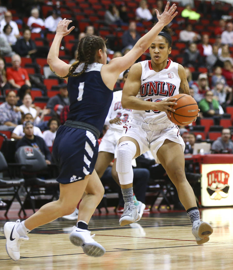 UNLV Lady Rebels guard Nikki Wheatley (10) drives against Utah State Aggies guard Eliza West (1) during the first half of a basketball game at the Cox Pavilion in Las Vegas on Friday, March 2, 201 ...