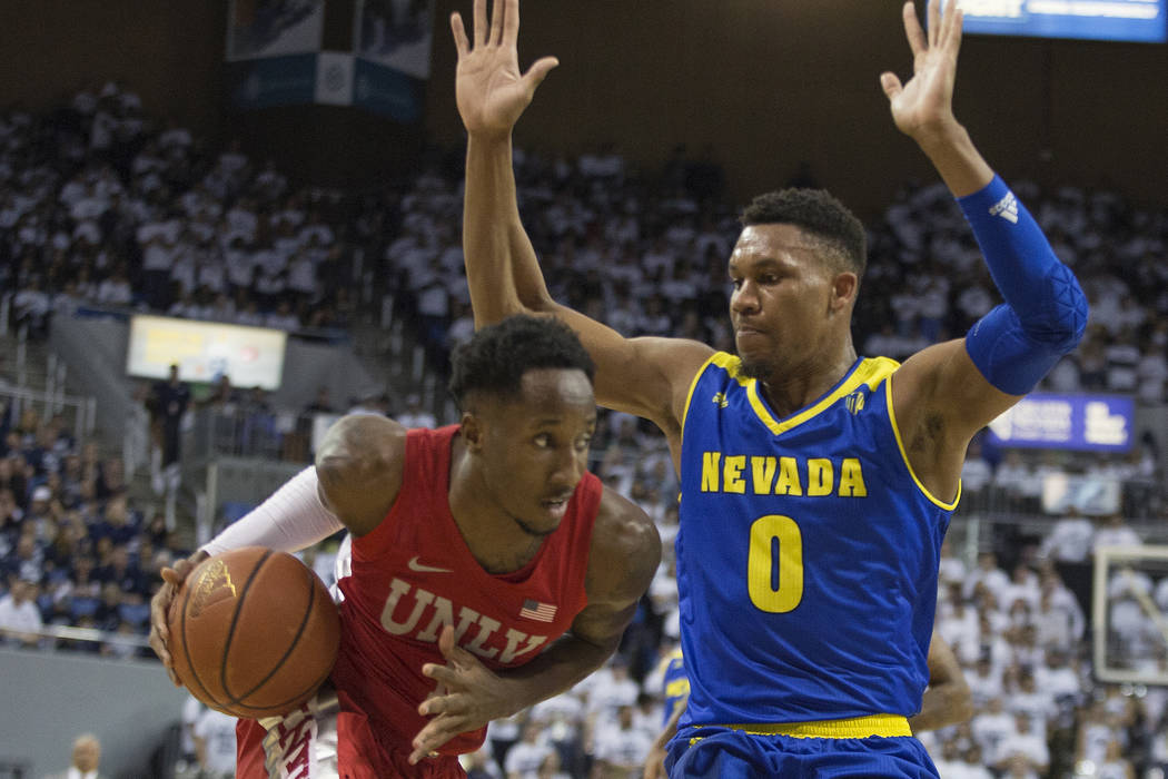 UNLV guard Kris Clyburn (1) drives on Nevada forward Tre'Shawn Thurman (0) during the first half of an NCAA college basketball game in Reno, Nev., Wednesday, Feb. 27, 2019. (AP Photo/Tom R. Smedes)
