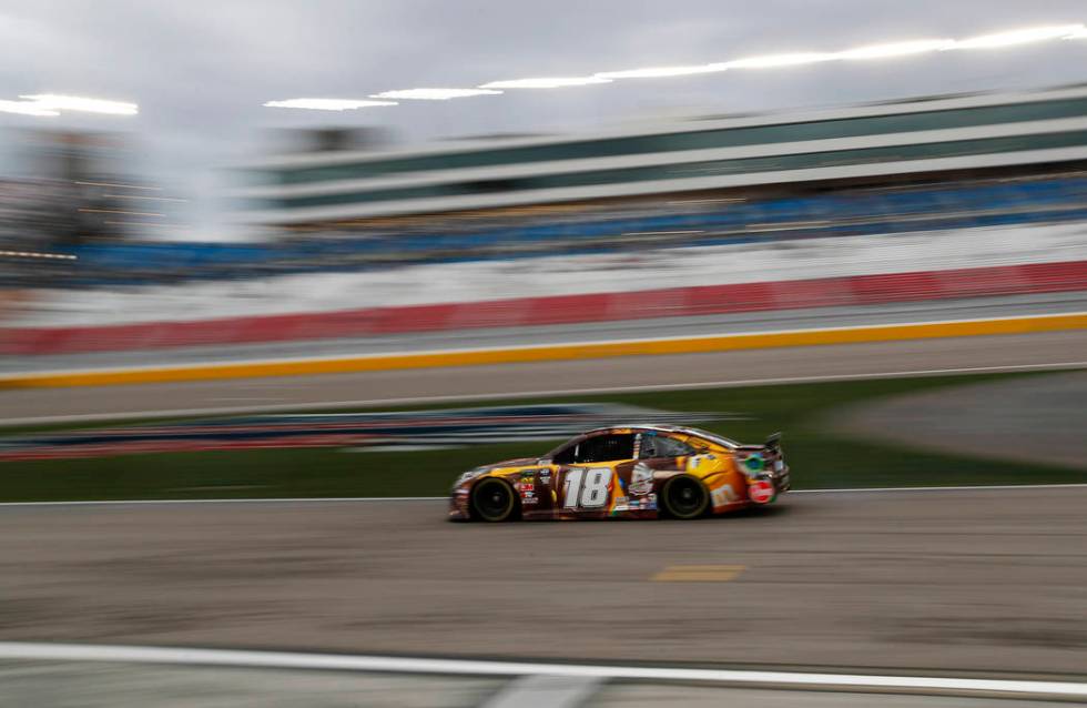 Kyle Busch (18) drives down pit lane during qualifying for the NASCAR Cup Series auto race at Las Vegas Motor Speedway, Friday, March 1, 2019, in Las Vegas. (AP Photo/John Locher)