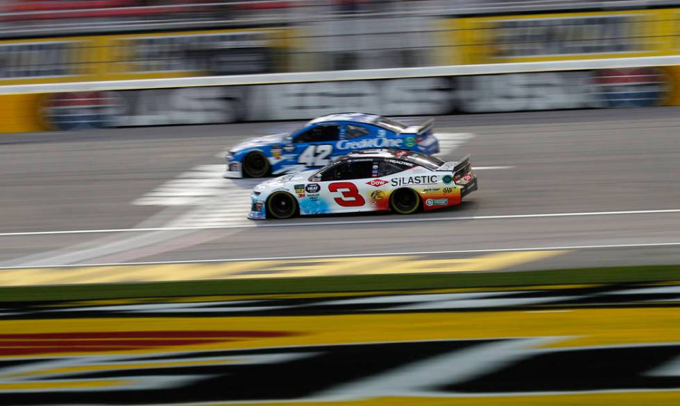 Austin Dillon (3) and Kyle Larson (42) drive during qualifying for a NASCAR Cup Series auto race at the Las Vegas Motor Speedway, Friday, March 1, 2019, in Las Vegas. (AP Photo/John Locher)