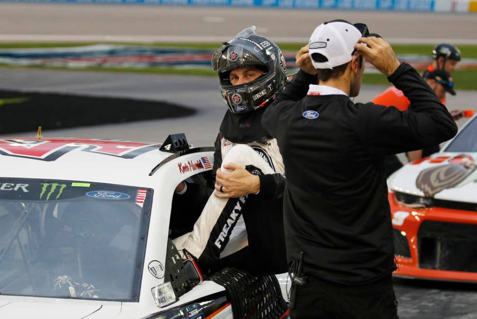 Kevin Harvick gets out of his car after winning the pole position during qualifying for a NASCAR Cup Series auto race at the Las Vegas Motor Speedway, Friday, March 1, 2019, in Las Vegas. (AP Phot ...