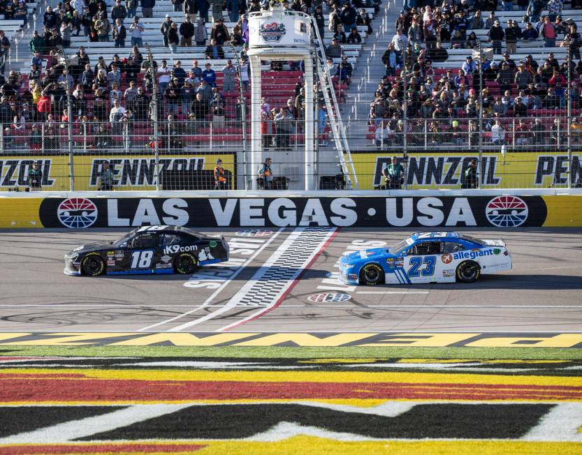 Kyle Busch (18) leads John Hunter Nemechek (23) in the final laps of the Boyd Gaming 300 on Saturday, March 2, 2019, at Las Vegas Motor Speedway, in Las Vegas. Busch won the 23rd annual running of ...