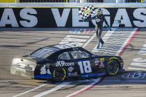 Kyle Busch (18) carries the checkered flag after winning the NASCAR Xfinity Series Boyd Gaming 300 on Saturday, March 2, 2019, at Las Vegas Motor Speedway, in Las Vegas. (Benjamin Hager Review-Jo ...