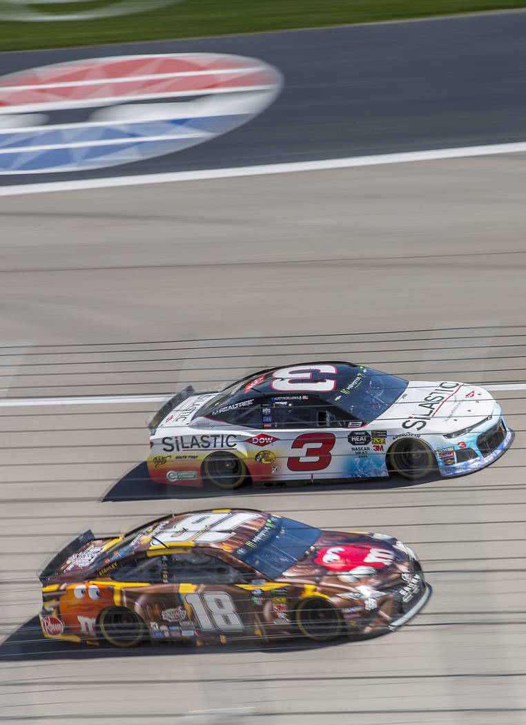 Kyle Busch (18) and Austin Dillon (3) compete for position around turn one during the Monster Energy NASCAR Cup Series Pennzoil 400 on Sunday, March 3, 2019, at Las Vegas Motor Speedway, in Las Ve ...