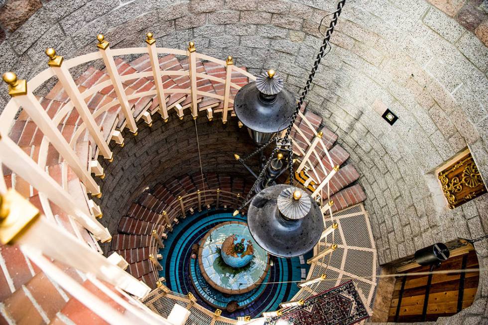 In the center of the stairs is a water fountain that features a world globe. (Tonya Harvey Real Estate Millions)