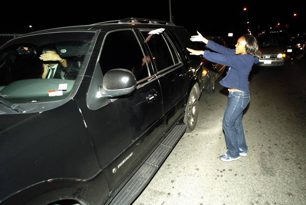 A Michael Jackson fan tries to touch the pop superstar through the window of his car Thursday, Nov. 20, 2003, after Jackson arrived back in Las Vegas after posting bail in Santa Barbara on child m ...