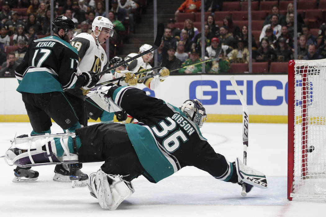 Anaheim Ducks' Ryan Kesler(17) and Vegas Golden Knights' Reilly Smith (19) watch as a shot by Golden Knights' William Karlsson enters the net for a goal against Ducks goaltender John Gibson (36) d ...