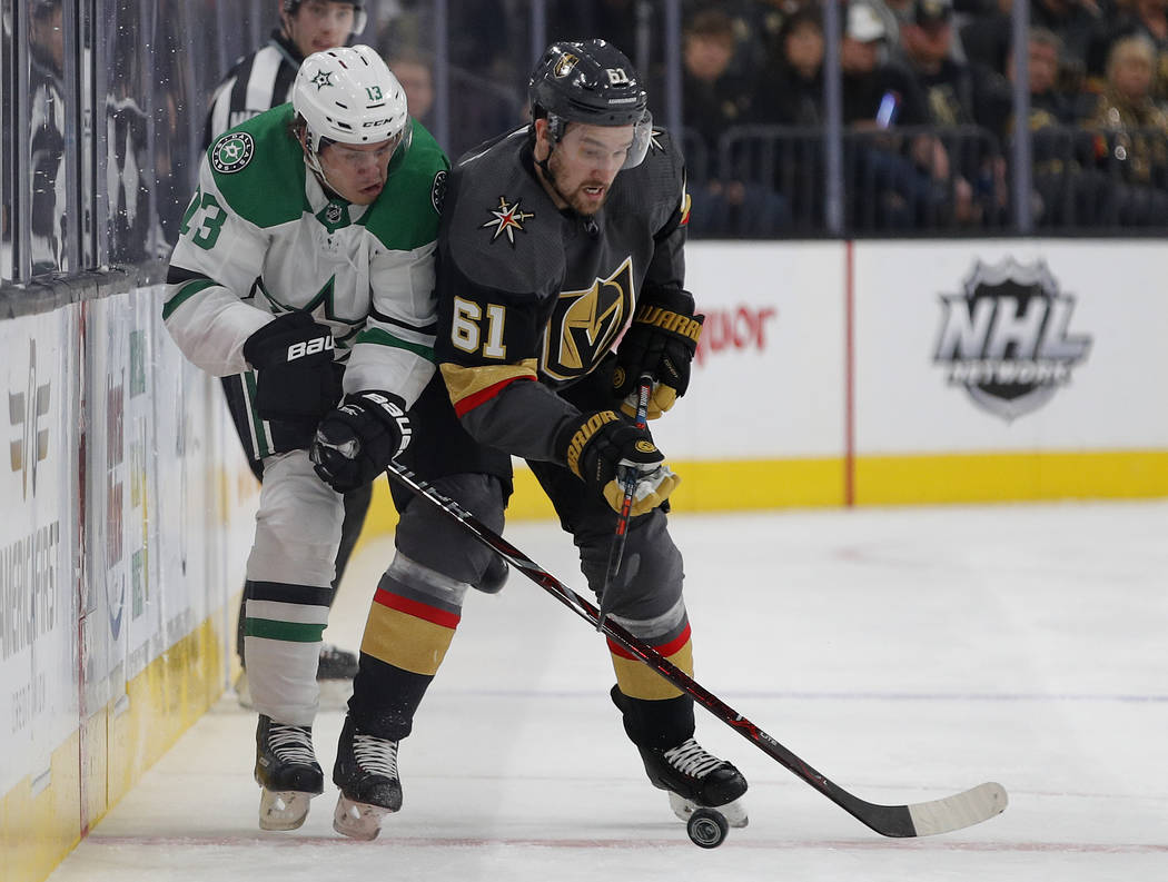 Dallas Stars center Mattias Janmark (13) vies for the puck with Vegas Golden Knights right wing Mark Stone (61) during the first period of an NHL hockey game Tuesday, Feb. 26, 2019, in Las Vegas. ...