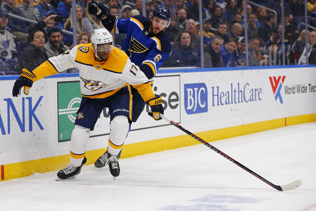 Nashville Predators' Wayne Simmonds (17) clears the puck against St. Louis Blues' Joel Edmundson (6) during the first period of an NHL hockey game Saturday, Feb. 26, 2019, in St. Louis. (AP Photo/ ...