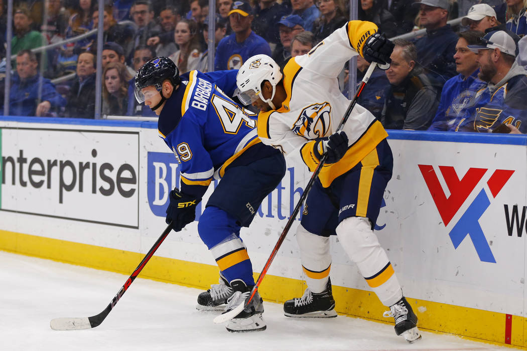 Nashville Predators' Wayne Simmonds (17) looks to steal the puck from St. Louis Blues' Ivan Barbashev (49) during the third period of an NHL hockey game Saturday, Feb. 26, 2019, in St. Louis. (AP ...