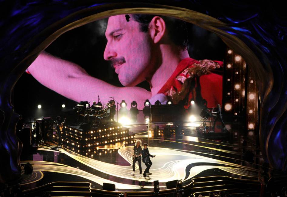 An image of Freddie Mercury appears on screen as Brian May, left, and Adam Lambert of Queen perform at the Oscars on Sunday, Feb. 24, 2019, at the Dolby Theatre in Los Angeles. (Photo by Chris Piz ...