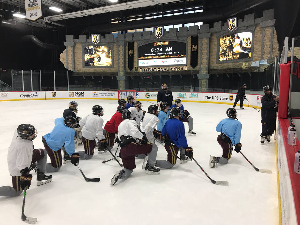 Faith Lutheran hockey coach Pokey Reddick conducts a blackboard session for the team on the rink at City National Arena. (Courtesy)