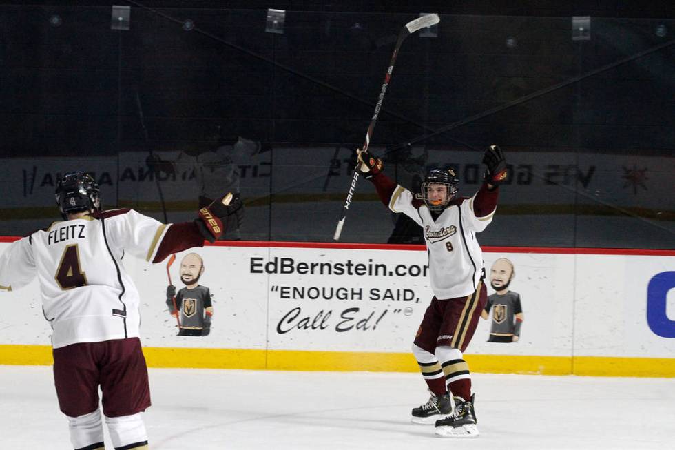 Faith Lutheran's Matty Johnson (8) celebrates with his teammate Colton Fleitz (4) after Johnson scored a goal against Utah's goaltender during the first period of a hockey game at the City Nationa ...