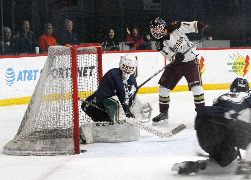 Faith Lutheran's Noah McAnallen (11) scores a goal against Utah's goaltender Landon Palmer, left, during the second period of a hockey game at the City National Arena in Las Vegas, Saturday, Dec. ...