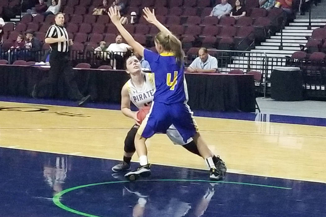 Moapa Valley's Lainey Cornwell looks for a shot against Lowry's Rebecca Kuskie in the Class 3A state semifinals at Orleans Arena on Friday, March 1, 2019. The Pirates won 43-38. (Damon Seiters/Las ...