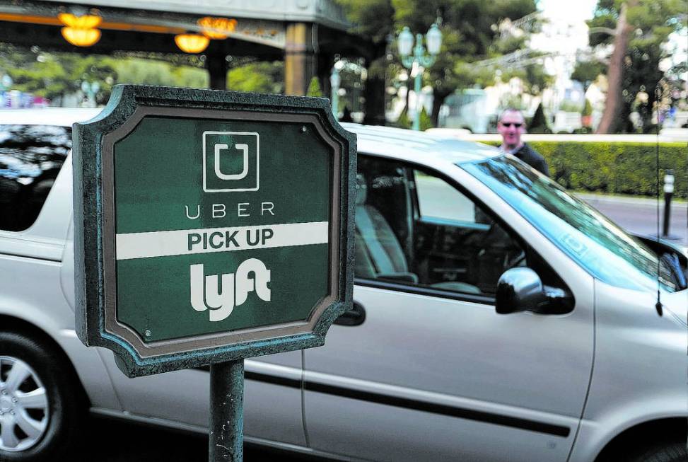 In this Jan. 14, 2016, photo, a driver waits to pick up passengers at an Uber and Lyft pick up area at the Bellagio hotel and casino in Las Vegas. The advent of Uber and Lyft in Nevada last fall h ...