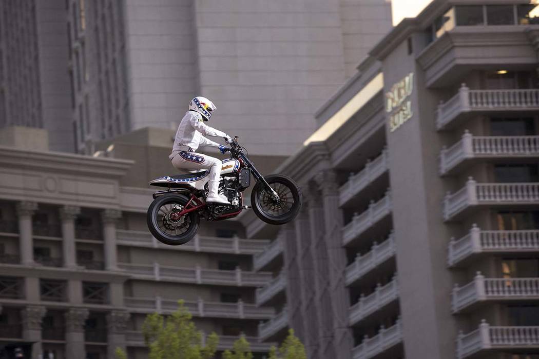Travis Pastrana jumps over the fountains at Caesars Palace on an Indian Scout FTR750 motorcycle during "Evel Live," a three-hour live tribute show to stuntman Evel Knievel, in Las Vegas on Sunday, ...