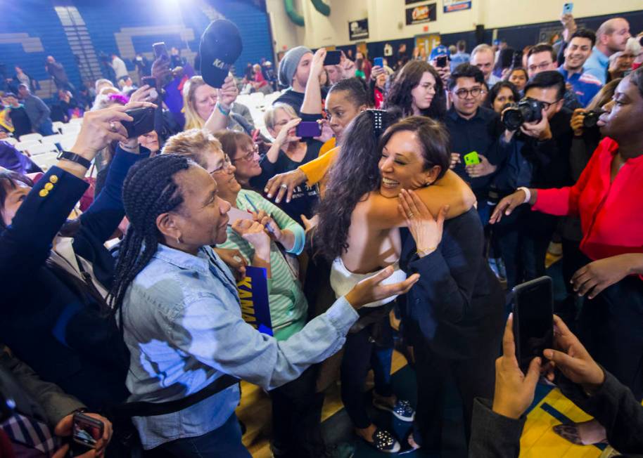 U.S. Sen. Kamala Harris, D-Calif., a Democratic presidential hopeful, right, is embraced by a supporter during a campaign rally at Canyon Springs High School in North Las Vegas on Friday, March 1, ...