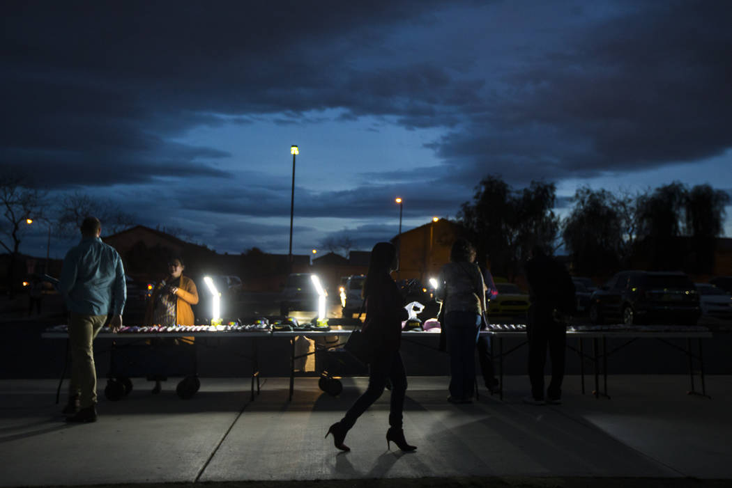 Vendors sell merchandise outside of a campaign rally for U.S. Sen. Kamala Harris, D-Calif., a Democratic presidential hopeful, at Canyon Springs High School in North Las Vegas on Friday, March 1, ...