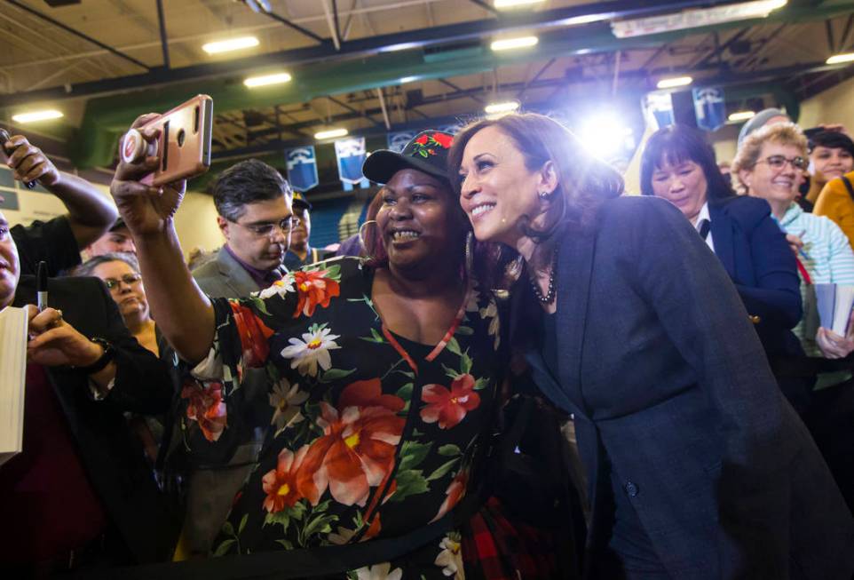 U.S. Sen. Kamala Harris, D-Calif., a Democratic presidential hopeful, right, poses for pictures with supporters during a campaign rally at Canyon Springs High School in North Las Vegas on Friday, ...