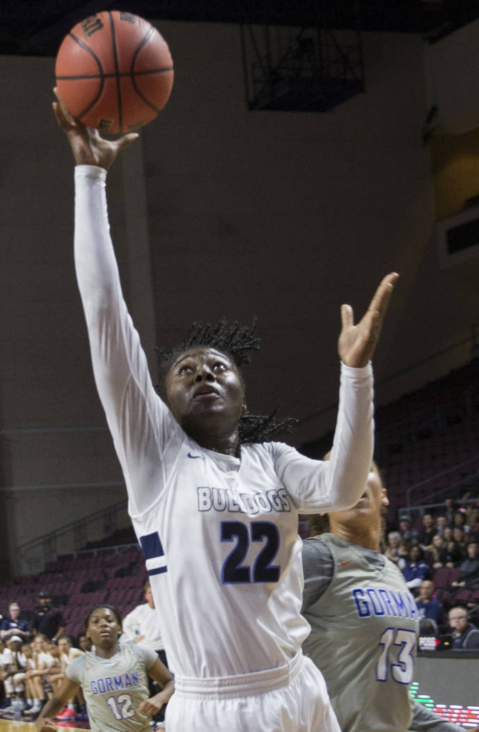 Centennial senior Eboni Walker (22) drives past Bishop Gorman senior Georgia Ohiaeri (13) in the second quarter of the Class 4A girls state championship game on Friday, March 1, 2019, at Orleans A ...