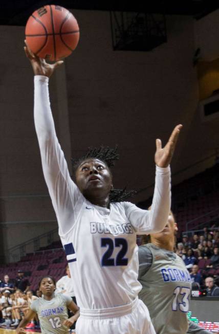 Centennial senior Eboni Walker (22) drives past Bishop Gorman senior Georgia Ohiaeri (13) in the second quarter of the Class 4A girls state championship game on Friday, March 1, 2019, at Orleans A ...