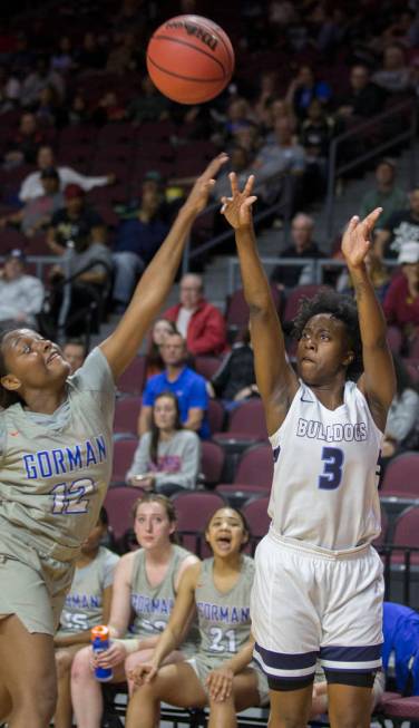 Centennial senior Quinece Hatcher (3) shoots a corner jump shot over Bishop Gorman senior Aaliyah Bey (12) in the second quarter of the Class 4A girls state championship game on Friday, March 1, 2 ...