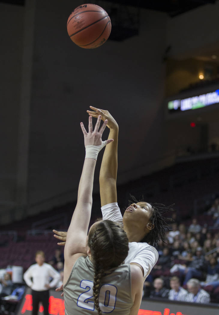 Centennial junior Daejah Phillips (15) shoots a jump shot over Bishop Gorman senior Tierney Holcombe (20) in the second quarter of the Class 4A girls state championship game on Friday, March 1, 20 ...