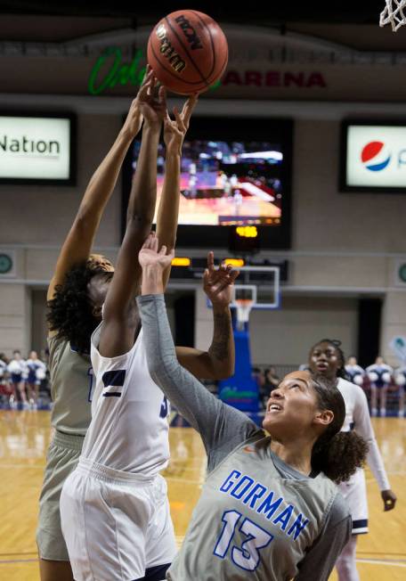 Bishop Gorman senior Georgia Ohiaeri (13) fights for a rebound with Centennial senior Quinece Hatcher (3) in the second quarter of the Class 4A girls state championship game on Friday, March 1, 20 ...