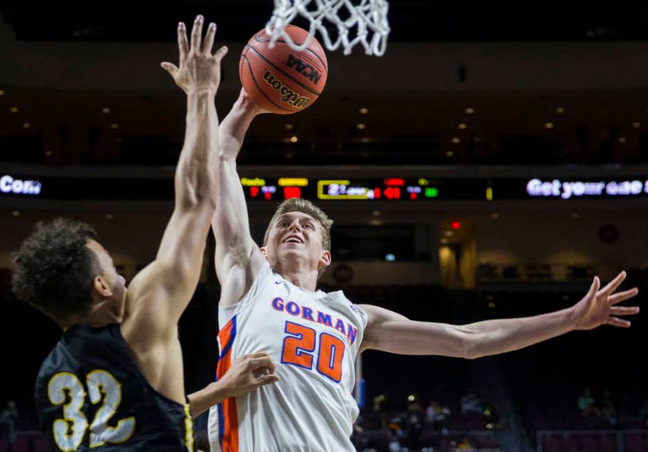 Bishop Gorman junior guard Noah Taitz (20) drives over Clark senior forward Ian Alexander (32) in the fourth quarter of the Class 4A boys state championship game on Friday, March 1, 2019, at Orlea ...