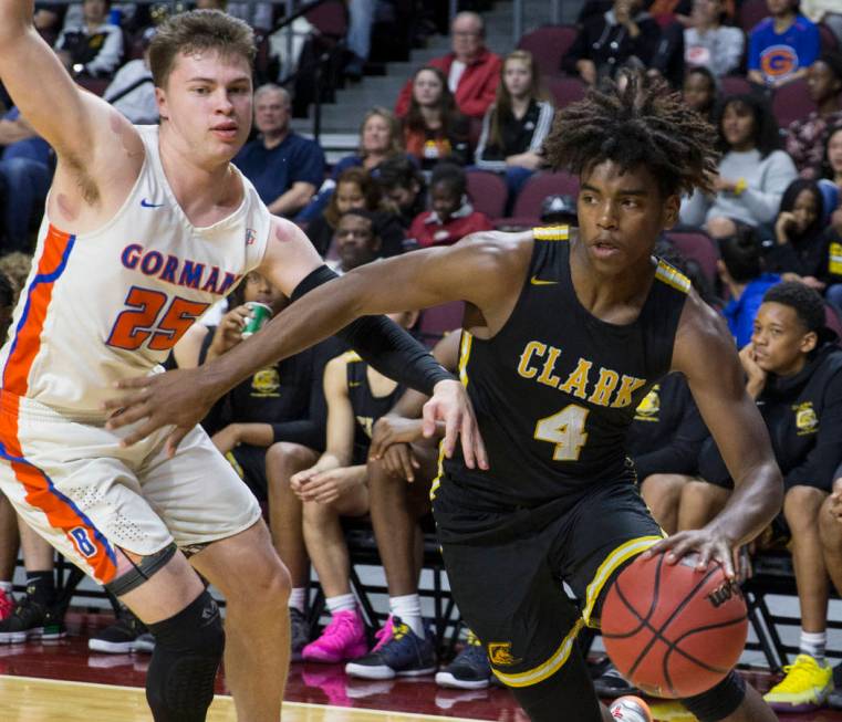 Clark senior guard Carlos Allen (4) drives baseline past Bishop Gorman senior guard Chance Michels (25) in the third quarter of the Class 4A boys state championship game on Friday, March 1, 2019, ...