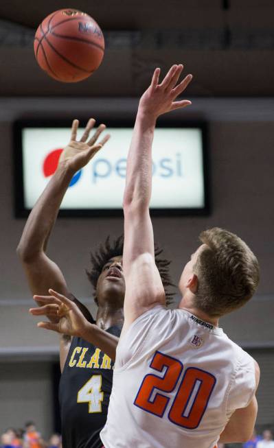 Clark senior guard Carlos Allen (4) shoots a jump shot over Bishop Gorman junior guard Noah Taitz (20) in the third quarter of the Class 4A boys state championship game on Friday, March 1, 2019, a ...