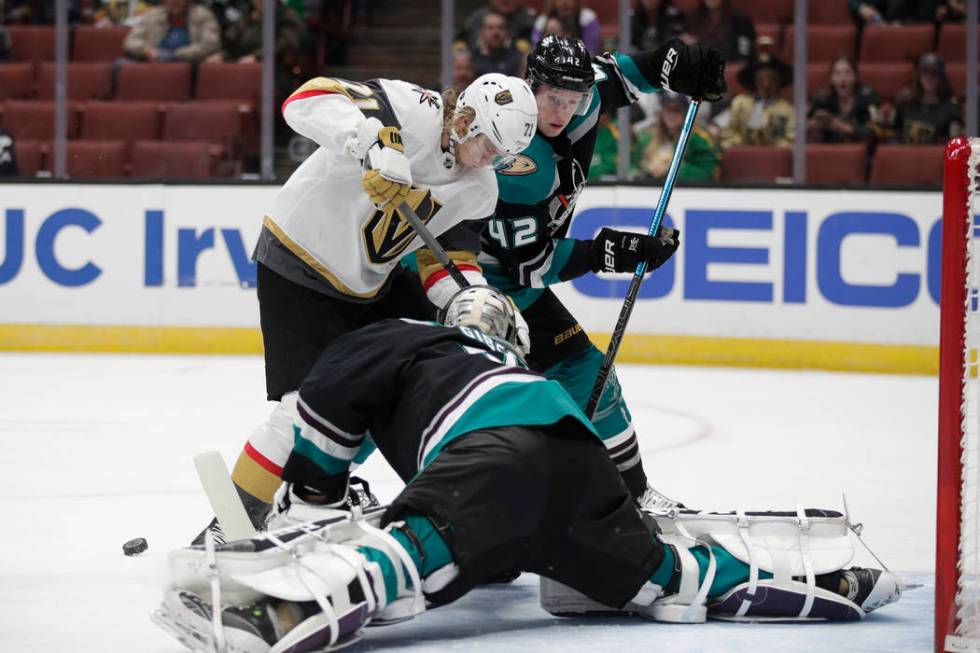 Anaheim Ducks goaltender John Gibson, bottom, makes a save against Vegas Golden Knights' William Karlsson during the first period of an NHL hockey game Friday, March 1, 2019, in Anaheim, Calif. (A ...