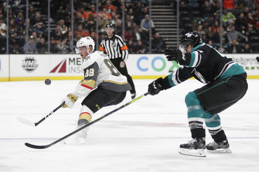 Vegas Golden Knights' Nate Schmidt, left, controls the puck under pressure from Anaheim Ducks' Hampus Lindholm during the third period of an NHL hockey game Friday, March 1, 2019, in Anaheim, Cali ...