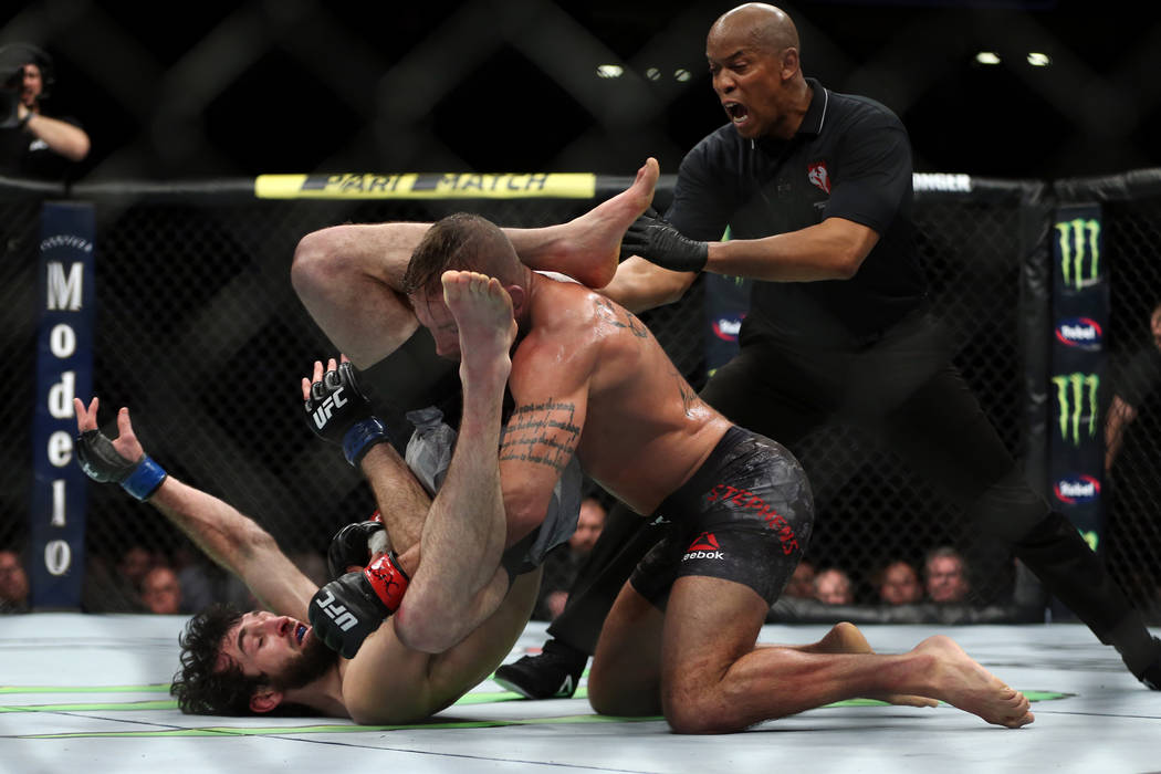 Jeremy Stephens, top, throws down a punch against Zabit Magomedsharipov in the featherweight bout during UFC 235 at T-Mobile Arena in Las Vegas, Saturday, March 2, 2019. Magomedsharipov won by una ...