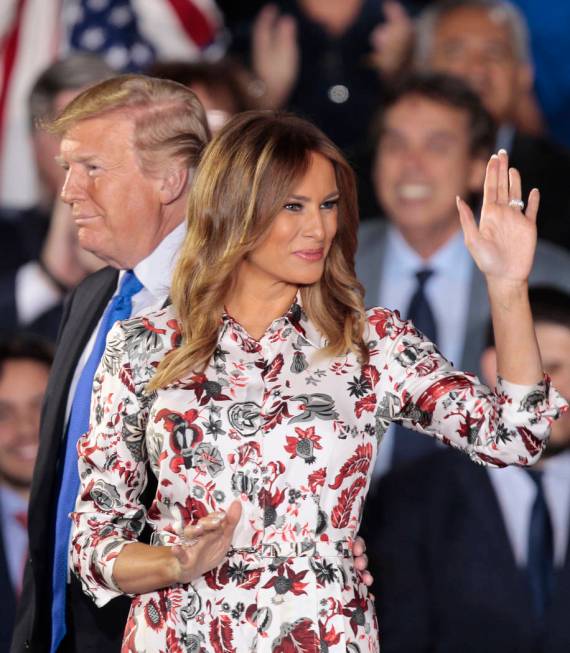 First lady Melania Trump, right, accompanied by President Donald Trump, waves before giving a speech to the Venezuelan American community at Florida International University in Miami, Monday, Feb. ...