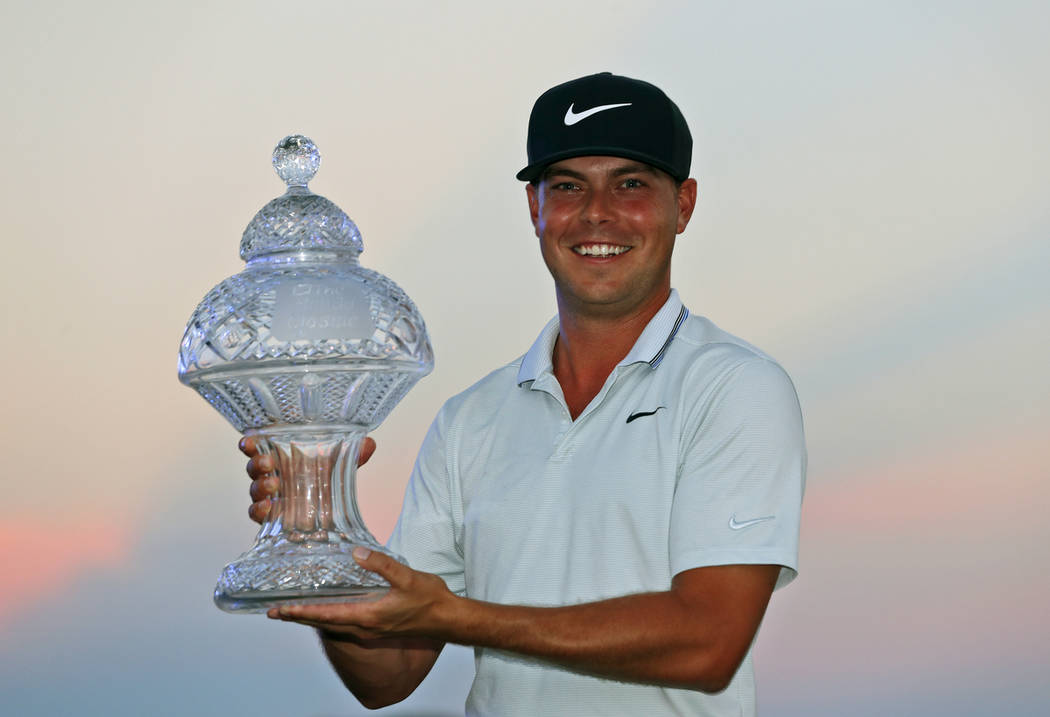 Keith Mitchell holds up his trophy after winning the Honda Classic golf tournament Sunday, March 3, 2019, in Palm Beach Gardens, Fla. (AP Photo/Wilfredo Lee)