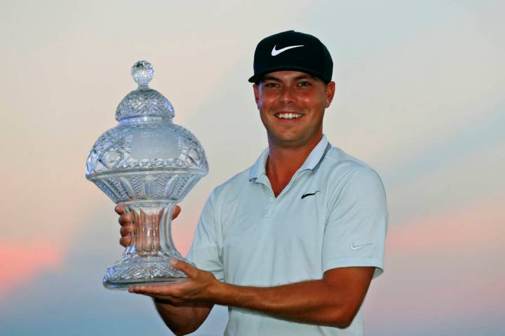 Keith Mitchell holds up his trophy after winning the Honda Classic golf tournament Sunday, March 3, 2019, in Palm Beach Gardens, Fla. (AP Photo/Wilfredo Lee)