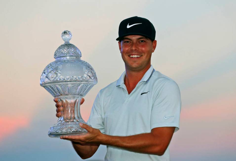 Keith Mitchell holds up his trophy after winning the Honda Classic golf tournament Sunday, March 3, 2019, in Palm Beach Gardens, Fla. (AP Photo/Wilfredo Lee)