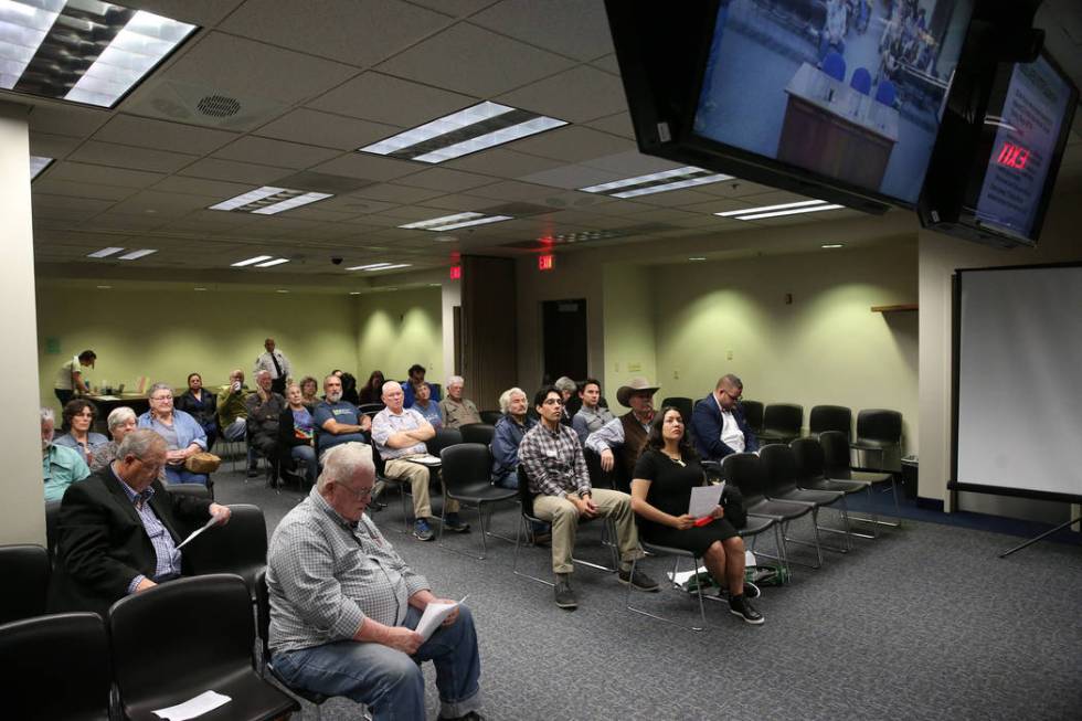 People watch a televised Senate Committee on Natural Resources meeting on a joint resolution opposing plans to expand an Air Force bombing range in Southern Nevada, at the Grant Sawyer State Offic ...