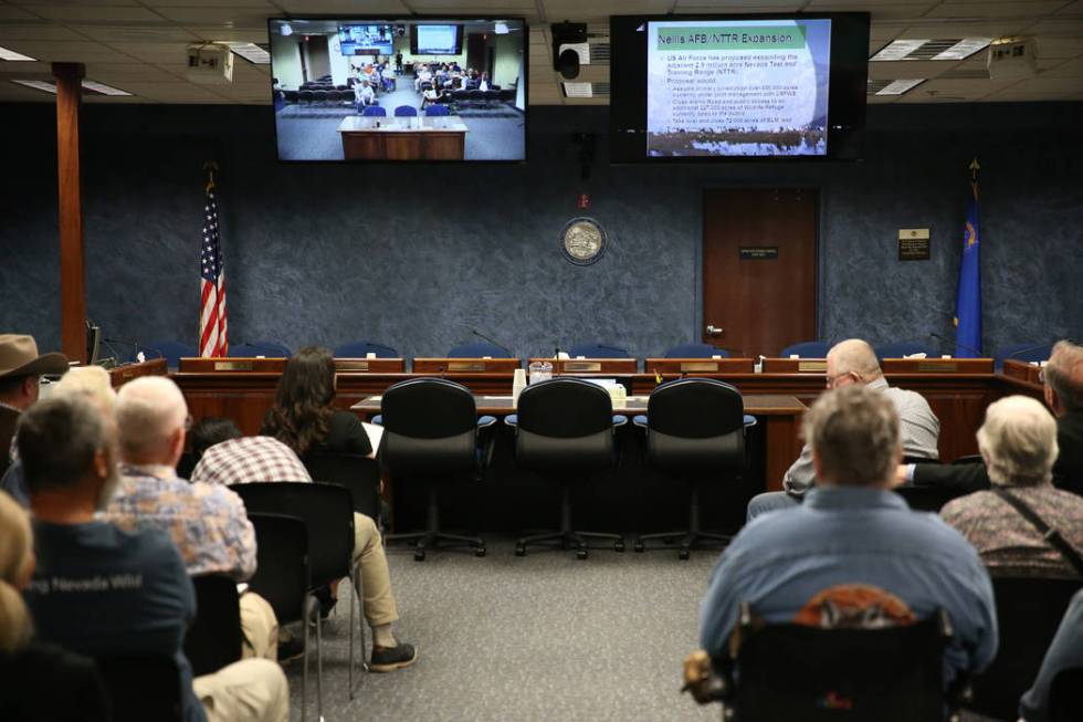 People watch a televised Senate Committee on Natural Resources meeting on a joint resolution opposing plans to expand an Air Force bombing range in Southern Nevada, at the Grant Sawyer State Offic ...